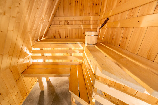  Interior of a traditional wooden Finnish sauna or Russian banya with benches and a bucket in Karelia, Russia