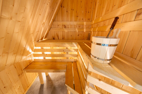  Interior of a traditional wooden Finnish sauna or Russian banya with benches and a bucket in Karelia, Russia