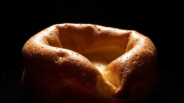 Yorkshire pudding on black background with spotlight