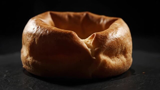 Yorkshire pudding cooling down on dark background