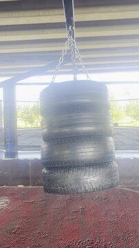 Stack of vehicle tires displayed outdoors. automotive products, transport equipment, retail storage.