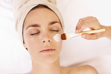 Obraz premium Hands, facial and brush with woman in spa for pore detox, skincare and deep cleaning cosmetics. Clay treatment, beauty glow and face mask with above of person in salon for purifying minerals