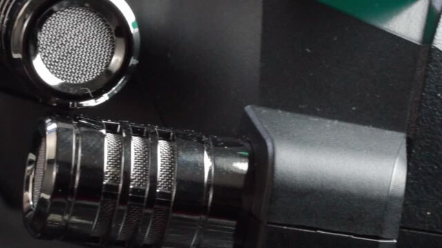Macro close up of XLR audio cable connected to line in port on professional audio device. Detailed technology footage showcasing audio connection, sound equipment and recording setup.