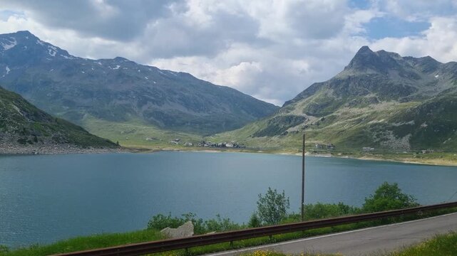 Lago di Montespluga at Spl&uuml;gen Pass, Italy, offering spectacular views of a serene mountain reservoir surrounded by the untouched beauty of the Italian Alps under partly cloudy sky