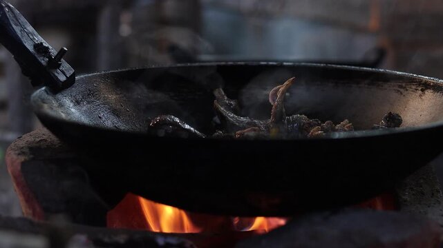 Authentic Thai hill tribe home kitchen where traditional local food is being prepared using simple cooking methods and fresh natural ingredients. This rustic scene highlights indigenous culinary tradi
