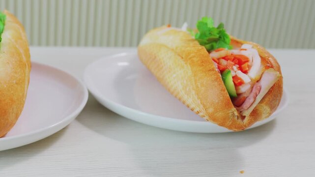 Two authentic Vietnamese banh mi sandwiches served on plates