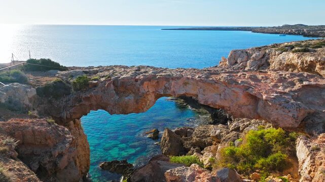 Aerial view of Crow&rsquo;s Arch in Cyprus. Natural rock arch, rugged cliffs and turquoise sea create a dramatic coastal landscape.