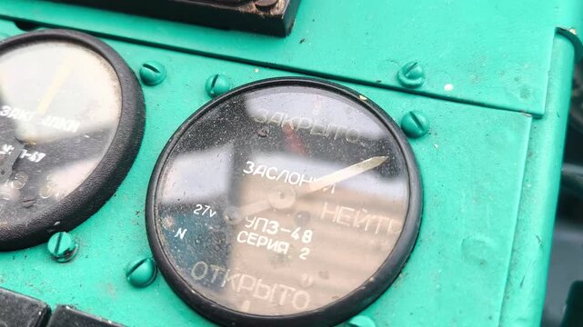 A close-up of the indicator of the position of the engine dampers in the cockpit of the AN-2 aircraft. Dashboard detail during pre-flight preparation.
