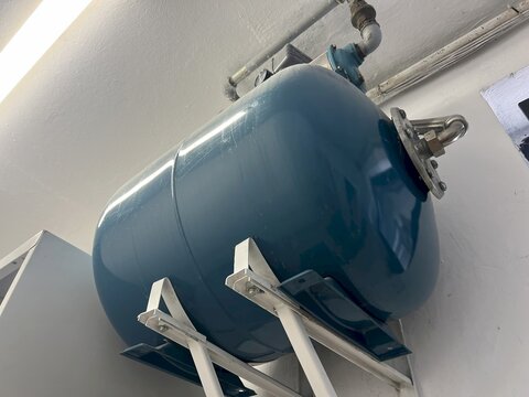 Commercial water booster pump and storage pressure tank indoors