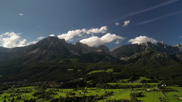 Alpine Meadow: A Lush Green Hillside with Wilder Kaiser Mountain Range as Background