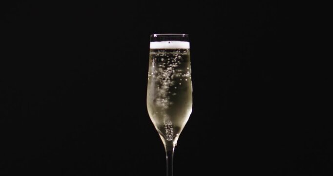 Champagne pouring into a glass with sparkling bubbles. Champagne wine pouring slowly into a clear glass. Champagne sparkling bubbles rising during pouring. Champagne prosecco style wine in a glass.