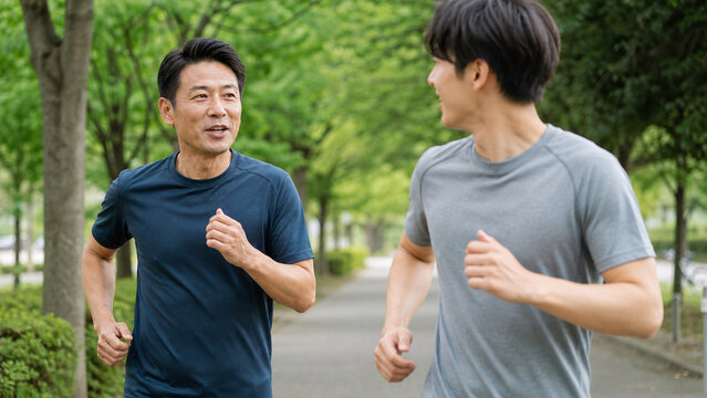 Japanese men jogging together in park conversation