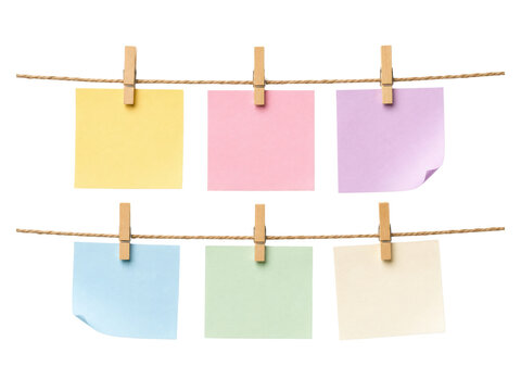 Six colorful paper notes hung with wooden clothes clips on a rope isolated on transparent.