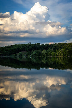 Billowing cloud domes roll across a clear sky with soft forms and gentle shading shaped by evening sun capturing the peaceful beauty of fair weather and open air space