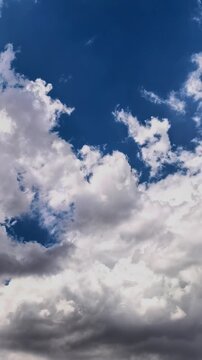 Storm clouds open to reveal patches of blue sky in time lapse, dramatic weather transition, atmospheric motion, changing cloudscape, nature background.