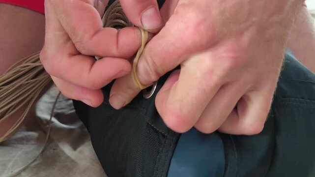 Close-up of hands laying parachute lines. Preparation of the parachute system before jumping in compliance with safety requirements.

