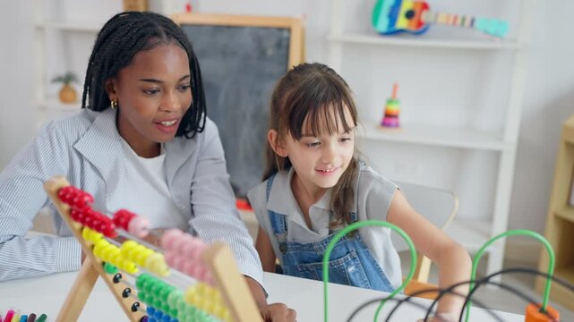 African tutor use educational toy help little child learn basic skills. 