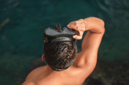 Swimmer adjusting snorkel mask in the Mediterranean Sea