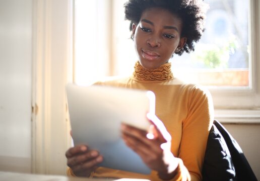 Young Black woman working on a tablet computer