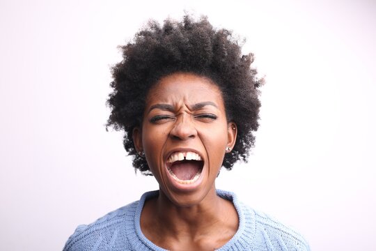 Frustrated young Black woman screaming loudly