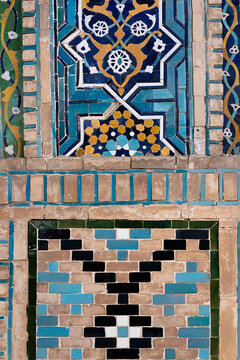 Ornamental tilework detail on Nadir Divan Begi Madrasah in Bukhara showing intricate mosaic and geometric brick patterns. Ideal for travel publications, cultural heritage features, design inspiration.