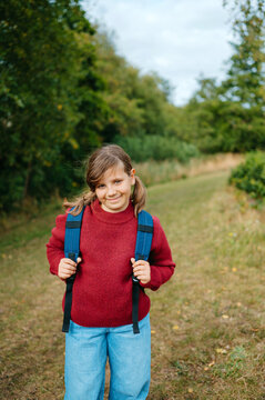 Smiling girl with backpack ready for the new school year