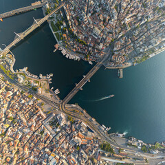 Fototapeta premium Istanbul, Turkey. Top-down aerial view of Galata Bridge over Golden Horn, Bosphorus strait, Halic Metro Bridge, and districts from above. Aerial view