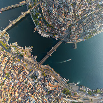 Istanbul, Turkey. Top-down aerial view of Galata Bridge over Golden Horn, Bosphorus strait, Halic Metro Bridge, and districts from above. Aerial view
