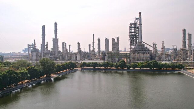 Aerial view of petrochemical refinery with towers and pipelines. 