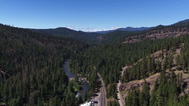Aerial of Naches River valley through Washington Wenatchee National forest and mountains in summer time along WA 410