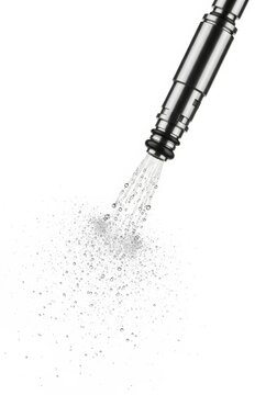 Close-up of a modern fuel injector atomizing a fine liquid spray for optimal engine performance and efficiency