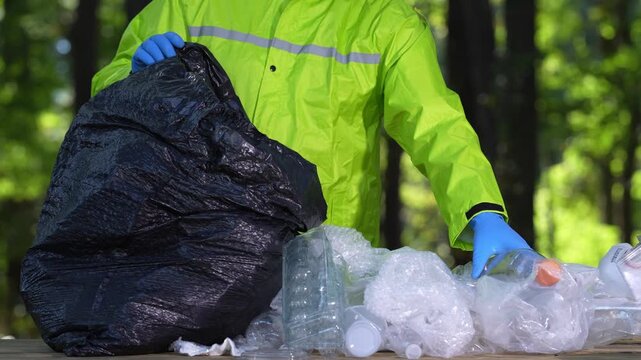 Volunteers clean parks from waste. Hands pick up plastic bottles to protect the planet. Global pollution. Plastic litter harms the environment. Rubbish cleanup. Bag of trash and eco actions. Pollution