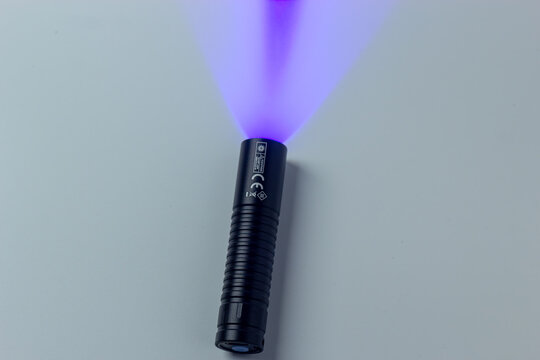 Powerful UV Flashlight Beam On White Background