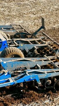 A Tractor Plowed A Field With A Plow Close-up In The Spring. Beginning Of Field Work In The Field In The Spring.