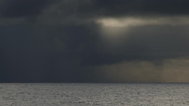 Dark Atlantic Ocean and stormy clouds as seen from the moving sailing boat
