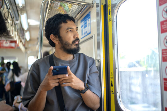 Indonesian Passenger Looking Through Window Inside KRL Commuter Train