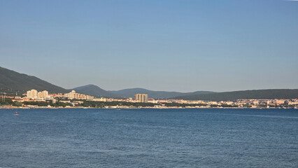 Fototapeta premium Coastal Cityscape Under Clear Blue Sky