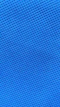 Blue colour non woven polypropylene biodegradable and reusable mesh fabric sheet surface abstract background texture for graphic design. Polyester medical cloth or fabric material seamless pattern.