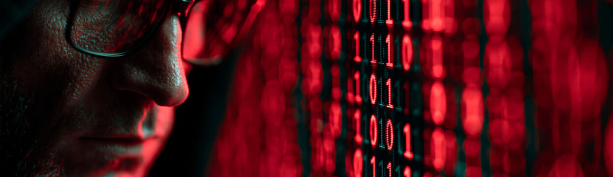 A detailed image of a computer screen displaying binary code, with a digital forensics analyst in the background, allowing for ample copy space for additional elements.