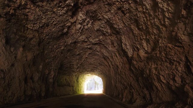 Inside the historic rock-cut stone tunnels of Vecchia Strada della Valcellina in Cellina gorge, Italy