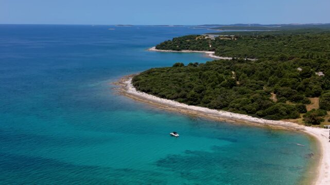 Mediterranean coast, little boat and blue Adriatic Sea near Brijuni Islands, Croatia. Panoramic aerial