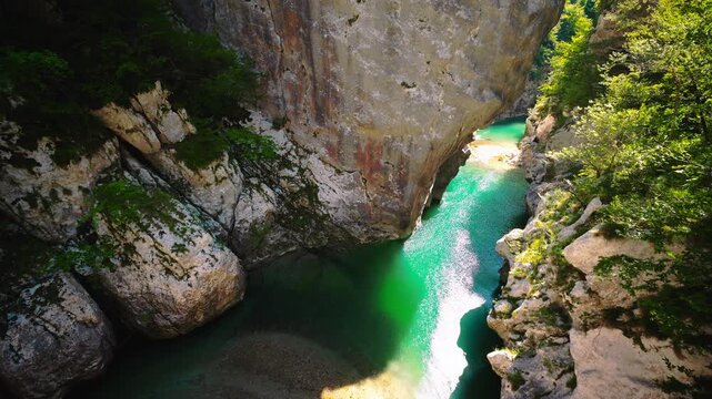 Clear mountain river flowing through steep limestone cliffs in Cellina gorge, Sentiero del Dint, Italy