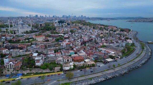 Istanbul cityscape with Blue Mosque and Hagia Sophia domes, minarets, historical buildings, and the Bosphorus strait. Perfect aerial view fly reverse drone panorama