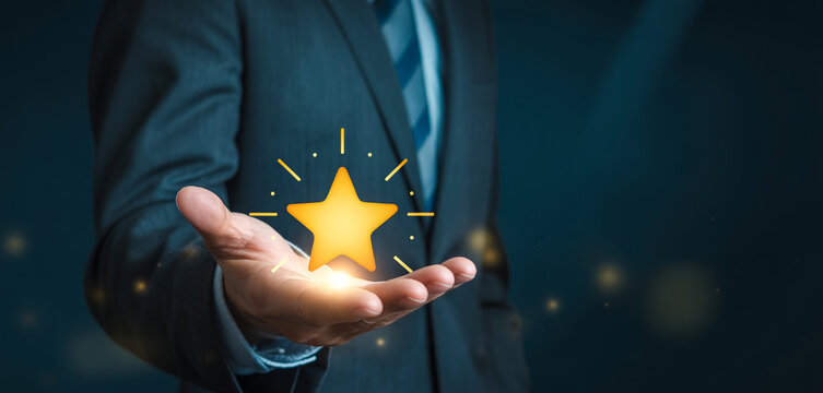 Businessman holding a golden star in his hand, a symbol of best service and quality.