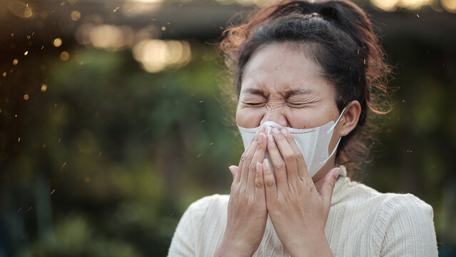 Close Up Woman in Face Mask Sneezing Heavily in Dust Smog for Pollen Allergy Concept