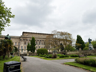 Fototapeta premium Overcast day in a formal park with historic neoclassical building and statues near St Georges Hall, Liverpool, UK