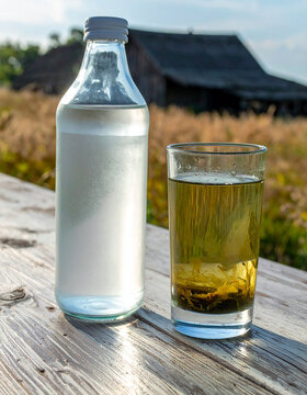 A glass of murky silted pond water placed side by side with a pristine glass of clear bottled water.