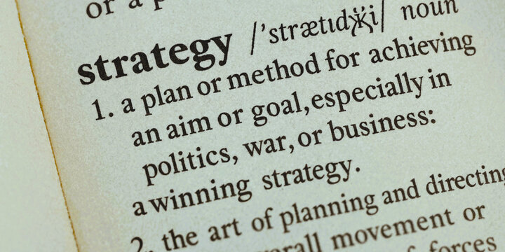 A close-up view of a dictionary page defining the word strategy
