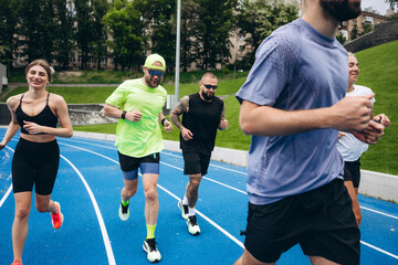 Obraz premium Group of runners jogging together during outdoor fitness session