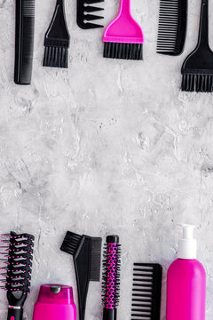 beauty salon pink work tools with comb for hair dress and coloring on stone background top view mock up